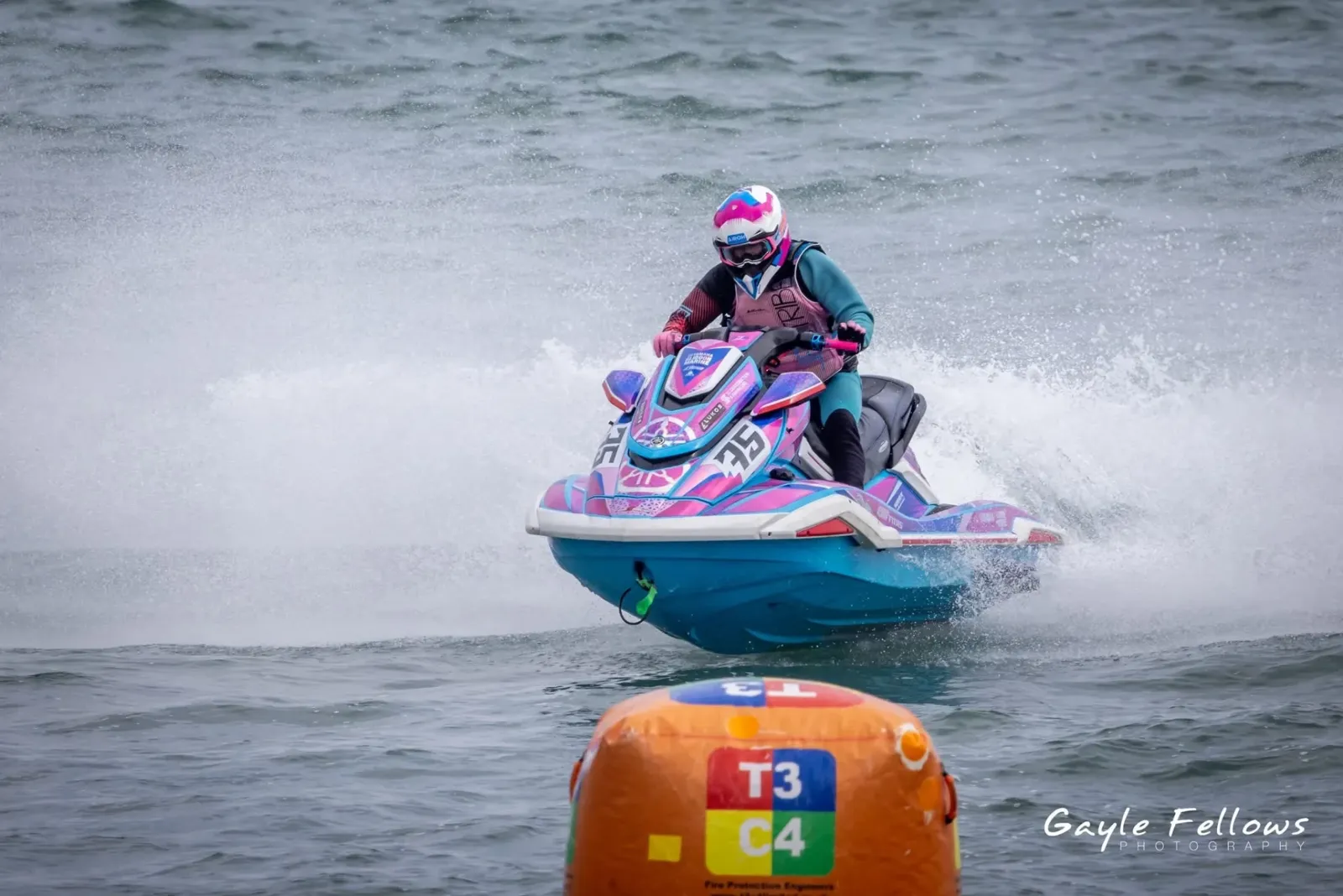 Pink and blue Yamaha #35 race sticker kit rounding a buoy
