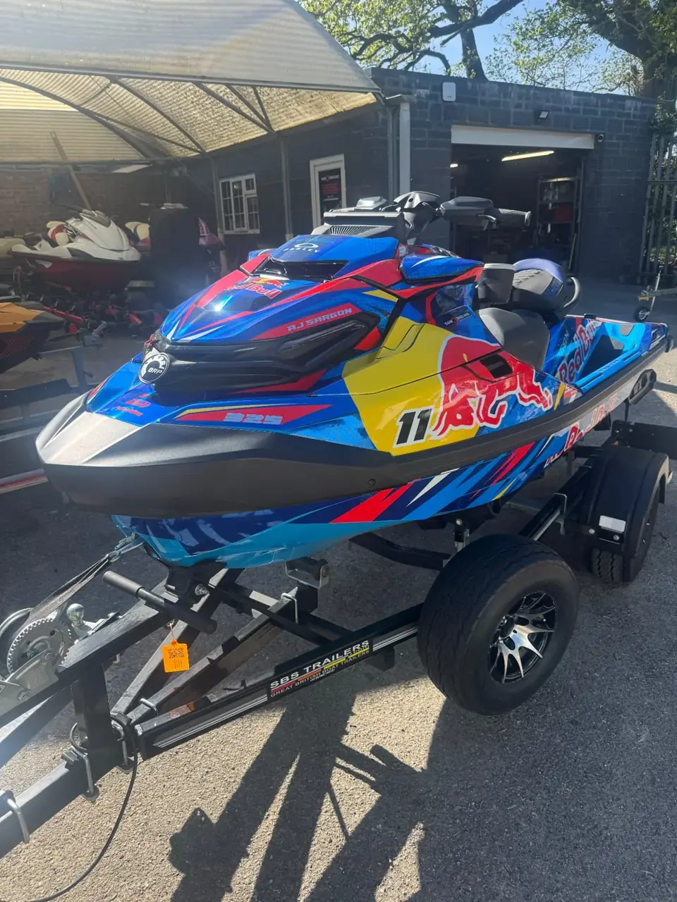 Blue, red and yellow Sea-Doo RXP-X 325 race sticker kit in sunlight