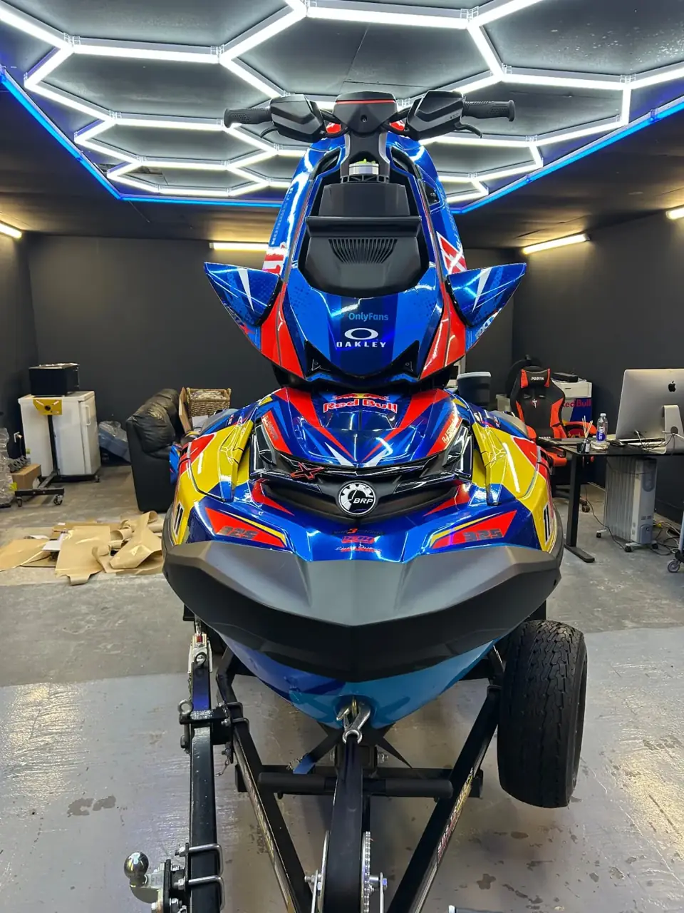 Head-on view of blue and red Sea-Doo RXP-X 325 sticker kit in the workshop