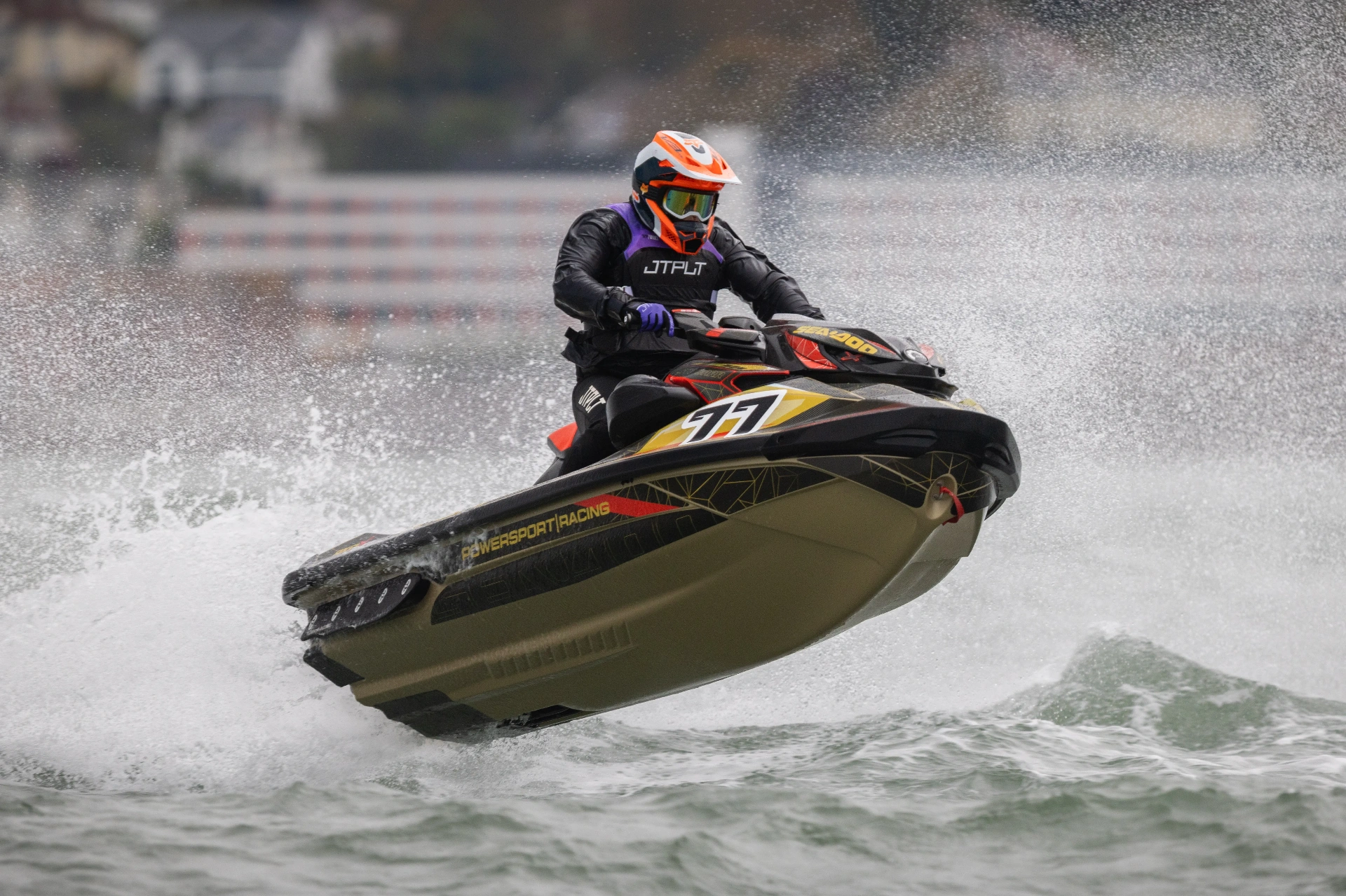 Jay Powersport Racing #77 Sea-Doo RXP-X mid-air — gold web design